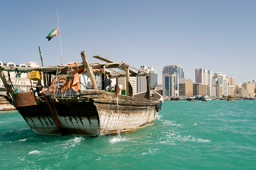 Doha,Qatar- April 24,2022 Traditional boats called Dhows are anchored in the port near the Museum of Islamic Art Park.
