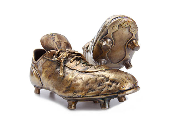 Golden soccer shoes isolated on white  metal stud stock pictures, royalty-free photos & images
