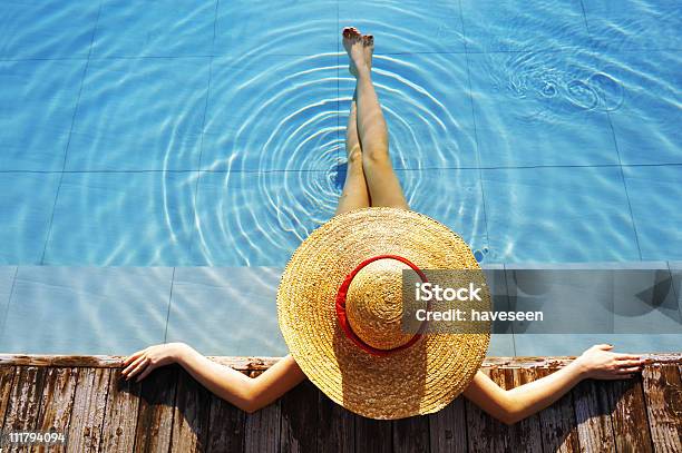 Woman Wearing Hat And Relaxing Poolside Stock Photo - Download Image Now - Hat, Only Women, Swimming Pool