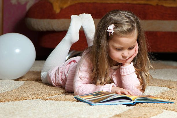 istock sweet little girl reading book 111804325