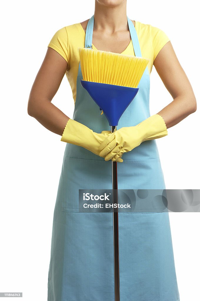 Homemaker in Apron with Broom and Rubber Gloves on White Maid in apron holding a broom  Adult Stock Photo