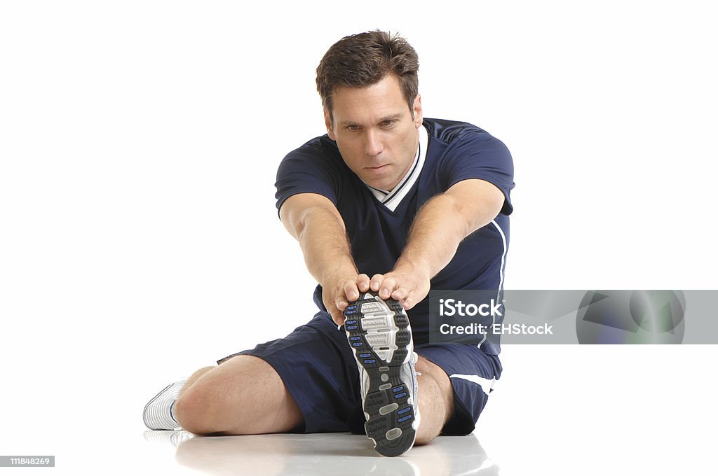 Masculino corredor de estiramiento aislado sobre fondo blanco - Foto de stock de Adulto libre de derechos