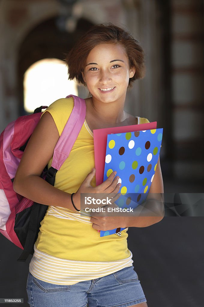 Hispanic Teenage Schoolgirl Holding Books on Campus A high school freshman with books Adult Stock Photo