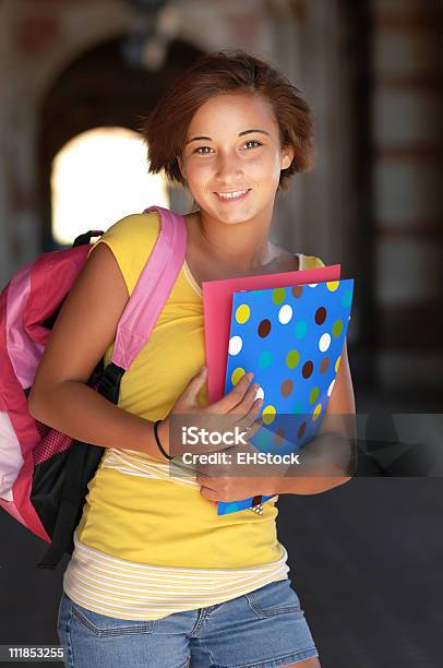 Hispanic Teenage Schoolgirl Holding Books On Campus Stock Photo - Download Image Now