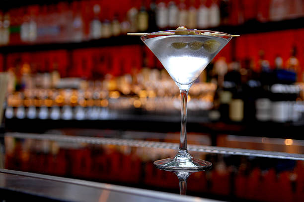 Dirty Martini on Bar with Bottles in Background