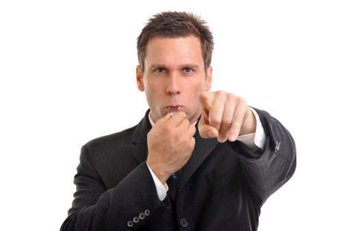 Businessman blowing whistle and pointing finger. More in Lightbox