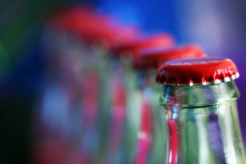 Closeup of row of soda bottles
