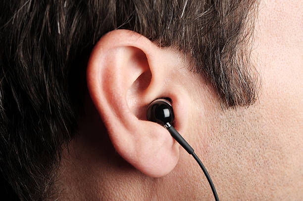 istock Earbud Headphone in Man's Ear Extreme Close Up 111870029