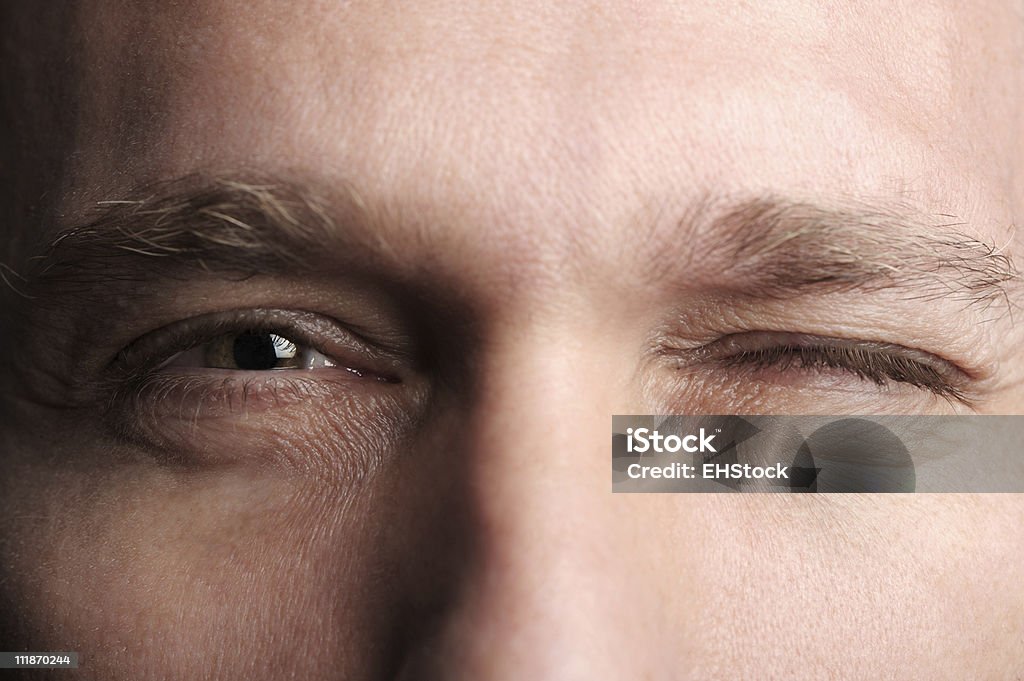 Man Winking Extreme Close up close up of a man winking, Focus on Eyes Blinking Stock Photo