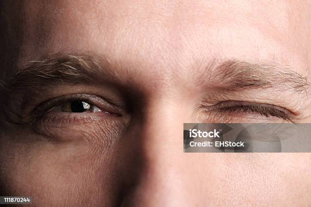 Man Winking Extreme Close Up Stock Photo - Download Image Now - Blinking, Winking, People