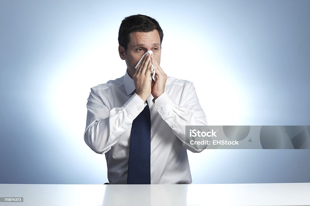 Empresario sonarse en fondo azul - Foto de stock de 40-44 años libre de derechos