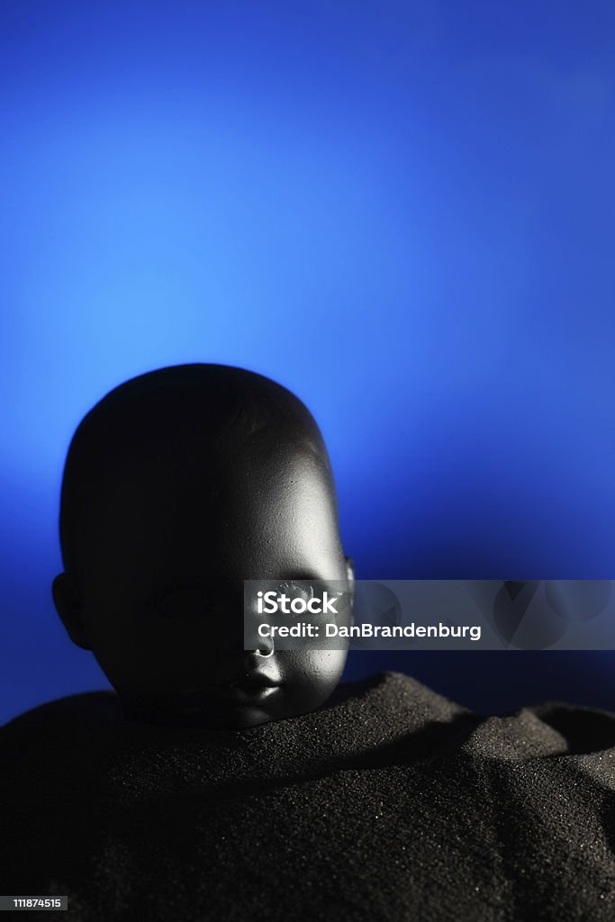 Head strange baby head in sand Artificial Stock Photo