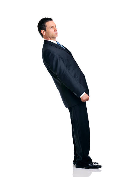 Businessman Leaning Over Backwards Isolated on White Background Businessman leaning impossibly over backwards, isolated Isolated on White Background person falling backwards stock pictures, royalty-free photos & images