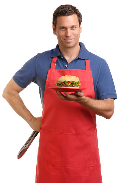 istock Man in Apron Holding Cheeseburger Isolated on White Background 111884462