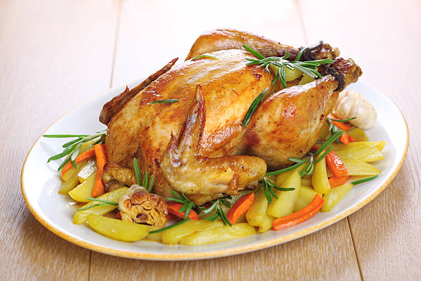 istock Whole roasted chicken with vegetables and rosemary 111903801