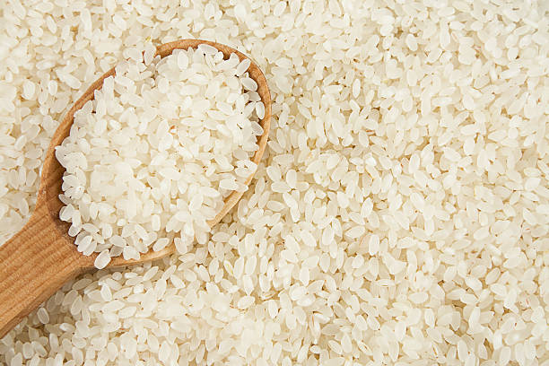 istock rice background and wooden spoon 111909787