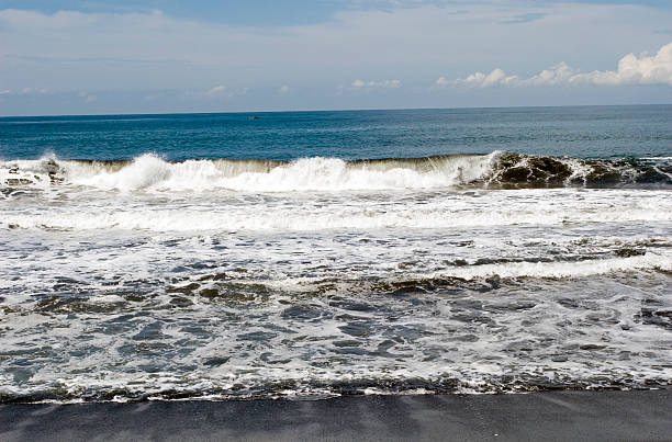 Waves breaking black sand beach - Guatemala stock photo