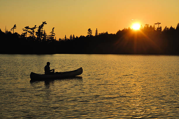Fishing in a Canoe Sunset on Remote Wilderness Lake  boundary waters canoe area stock pictures, royalty-free photos & images