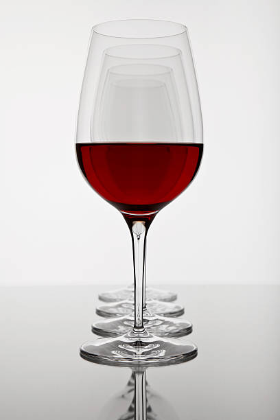 istock row of four wine glasses, first ist filled 111921108