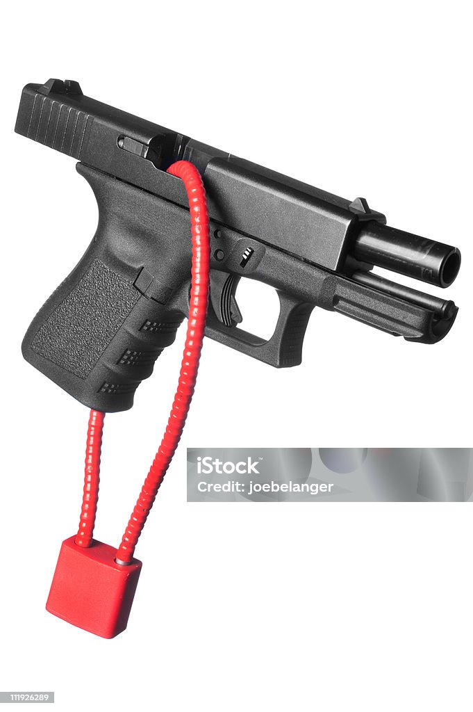 An isolated image of a locked firearm A hand gun firearm is locked with a safety cable to prevent anyone from firing the weapon. Gun Stock Photo