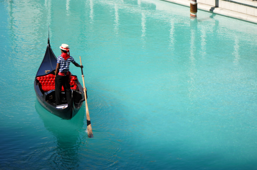 A gondolier meanders through the canals of Vegas
