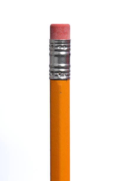 Erasers and pencil on yellow background, closeup
