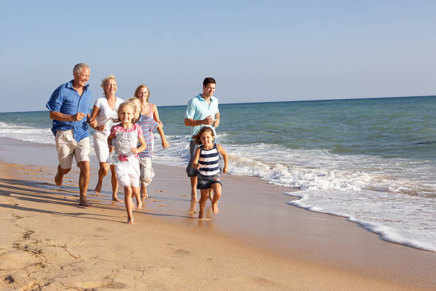 Family running on a beach