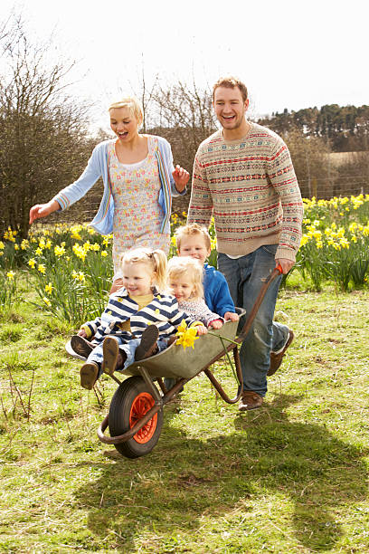 istock Father Giving Children Ride In Wheelbarrow 111931543