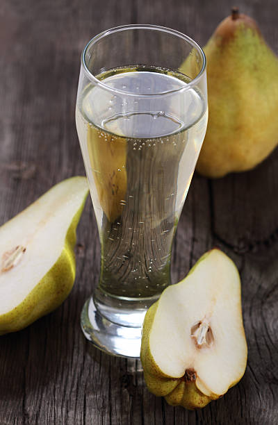 istock Glass of pear cider with cider halves 111932102