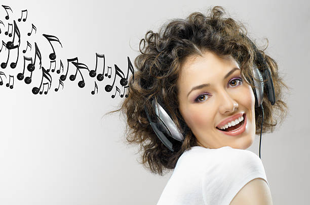 girl with headphones on the grey background