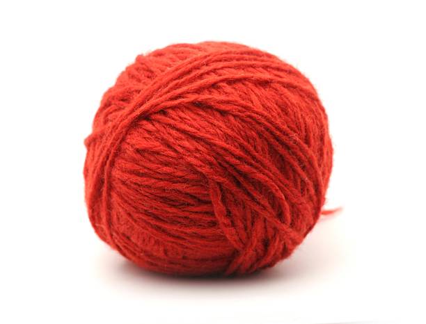 Ball of red yarn isolated on white
