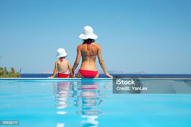 Young Mother With Daughter See To Sea Stock Photo - Download Image Now - Swimming Pool, Mother, Daughter