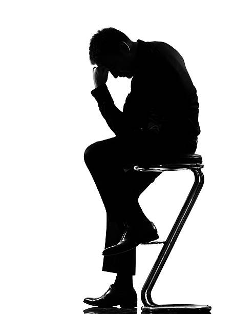istock A silhouette of a man who is depressed 111938652