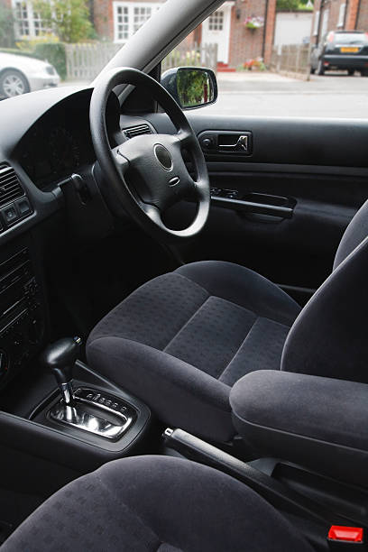 Cars interior on a car in the UK Interior of an european car with automatic transmission and gray velour cloth seats drivers seat stock pictures, royalty-free photos & images