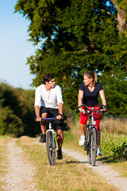 istock Man and woman exercising with bicycle 111945172