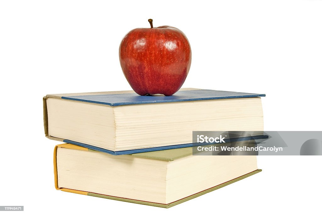 Two Books and an Apple Fiber to get you going and something to read when you get there.  Isolated on white with copy space. Apple - Fruit Stock Photo
