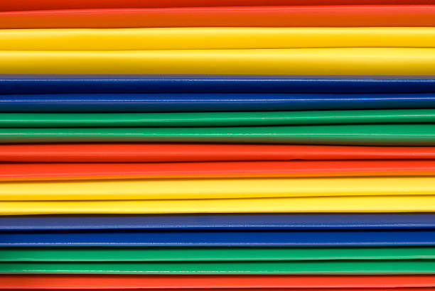 istock Close-Up of Brightly Colored Plastic File Folder Spines 111945733