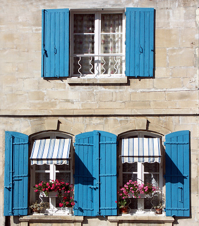 Old blue window and grey cement wall closed ancient facade shutter