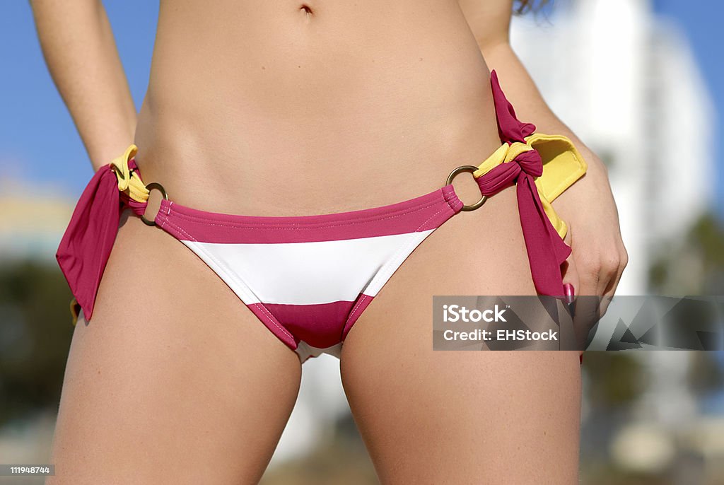 Pink and White Bikini Bottoms at Beach Pink and White Bikini Bottom Close Uphttp://www.erichoodphoto.com/istock/women.jpg Bikini Stock Photo