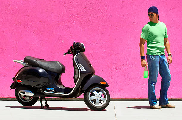 Man with Pink Wall Black Scooter Green Soda