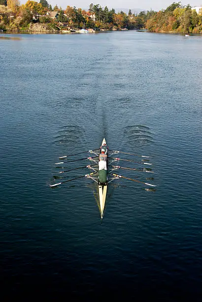 Photo of Quad Shell Racer with Four Rowers on Autumn Lake