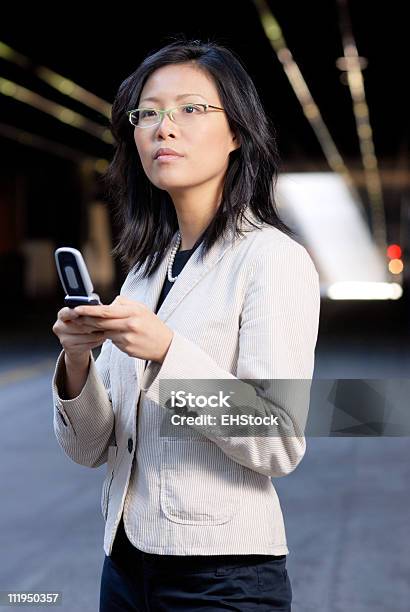 Young Asian Businesswoman Texting On Mobile Device Stock Photo - Download Image Now - 20-24 Years, 20-29 Years, Adult
