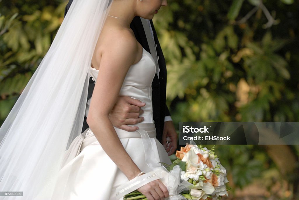 Bride and Groom walk together after Ceremony A bride and groom take a moment to let it sink inhttp://www.erichood.net/istock/weddingbanner.jpg Adult Stock Photo