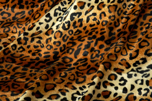 Soft fleecy faux fabric with a mottled pattern. Light leopard texture.