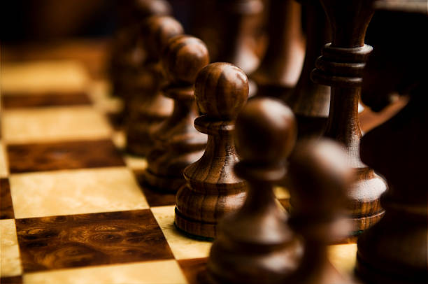 istock Black Chess Pawns in Line on Chessboard 111951990
