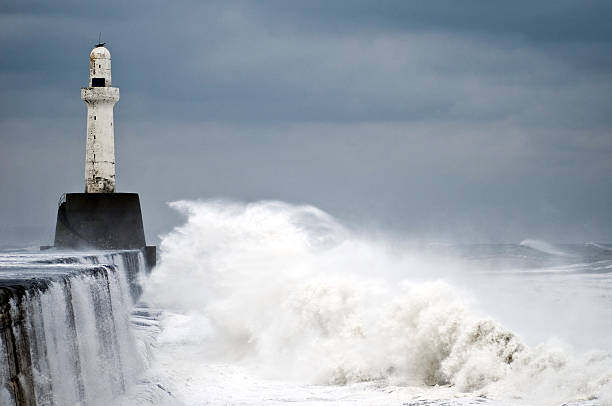 January storm cause waters to rage at Aberdeen leading light Another winter and another storm pounds the breakwater and leading light at Aberdeen harbour, January 2011, also see last years storm and other lighthouses. north sea waves stock pictures, royalty-free photos & images