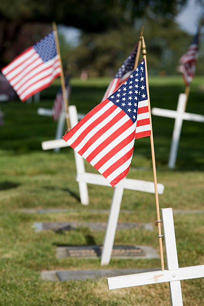 istock Memorial with white cross and US flag 111954623