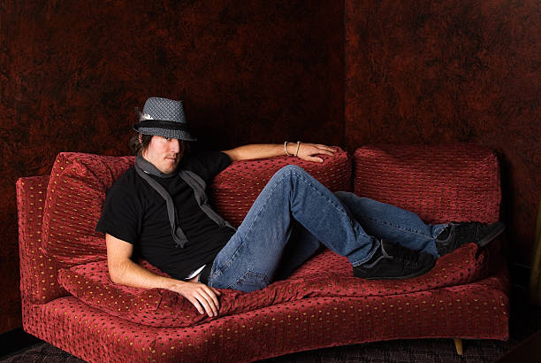 istock Cool young man on a red couch 111961001