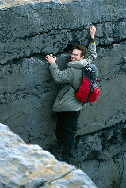 istock freeclimbing young man on a cliff 111962544