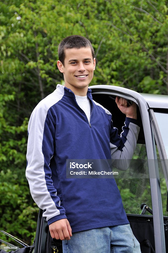 young male holding on a UTV-riding looking at the camera  Rooftop Stock Photo